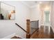 Upstairs hallway with hardwood floors, railing, and neutral paint at 2119 Dee Dee Muse Nw Ln, Atlanta, GA 30318