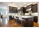 Kitchen featuring an island with seating, dark cabinetry, and stainless steel appliances at 2119 Dee Dee Muse Nw Ln, Atlanta, GA 30318