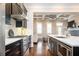 Modern kitchen featuring stainless steel appliances, dark wood cabinets, and a view into the living room at 2119 Dee Dee Muse Nw Ln, Atlanta, GA 30318