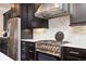 Modern kitchen design featuring stainless steel appliances, dark wood cabinets, and marble backsplash at 2119 Dee Dee Muse Nw Ln, Atlanta, GA 30318