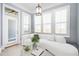 Bright and airy sitting area with large windows, plush seating, and stylish decor in the main bedroom at 2119 Dee Dee Muse Nw Ln, Atlanta, GA 30318