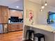 Eat-in kitchen boasts wood cabinets, stainless steel appliances, granite countertops, and modern pendant lights at 215 Piedmont Ne Ave # 602, Atlanta, GA 30308