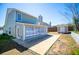 Exterior view of backyard with concrete patio, storage shed, and lawn at 104 Providence Dr, Carrollton, GA 30116