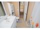 A tiled bathroom featuring a vanity with sink, toilet, shower curtain and a hallway doorway at 104 Providence Dr, Carrollton, GA 30116