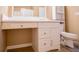 A tiled bathroom featuring a vanity with sink, toilet, and large mirror at 104 Providence Dr, Carrollton, GA 30116