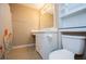 A tiled bathroom featuring a vanity with sink, toilet, mirror and floral-themed shower curtain at 104 Providence Dr, Carrollton, GA 30116