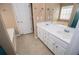 Bathroom featuring dual sink vanity with tile floors and a large mirror at 104 Providence Dr, Carrollton, GA 30116