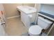 A tiled bathroom featuring a vanity with sink, toilet, and floral-themed shower curtain at 104 Providence Dr, Carrollton, GA 30116