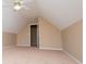 A carpeted bedroom includes a doorway, and a ceiling fan with lights at 104 Providence Dr, Carrollton, GA 30116