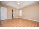 Bright bedroom with hardwood floors, tray ceiling, and ceiling fan at 104 Providence Dr, Carrollton, GA 30116