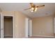 A carpeted bedroom includes a doorway, a ceiling fan with lights and a window at 104 Providence Dr, Carrollton, GA 30116