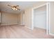 A carpeted bedroom features a closet, a ceiling fan with lights and a window at 104 Providence Dr, Carrollton, GA 30116