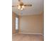 A cozy bedroom featuring carpet, a ceiling fan with lights, and a bright window at 104 Providence Dr, Carrollton, GA 30116