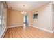 Dining room features wood floors, a chandelier, and a view into the kitchen at 104 Providence Dr, Carrollton, GA 30116