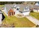 Aerial view of home with well-maintained lawn, driveway, and landscaping at 104 Providence Dr, Carrollton, GA 30116