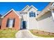 A two-story house features a brick facade, neutral siding, dark shutters, and a black front door at 104 Providence Dr, Carrollton, GA 30116