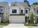 Charming two-story home features a white brick and siding, black trim windows, and a two-car garage at 1063 Crest Mill Dr, Marietta, GA 30008