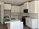 Well-lit kitchen features white cabinets, stainless steel appliances, and a stylish backsplash at 1063 Crest Mill Dr, Marietta, GA 30008
