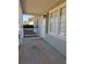 The front porch of a single-story home has a white railing and traditional light fixture at 325 Villa Rosa Way, Temple, GA 30179