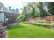 Lush backyard with a well-maintained lawn, a patio area, and beautiful landscaping at 513 Beecham Dr, Smyrna, GA 30082