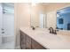 Bathroom featuring double sinks, modern fixtures, and a glimpse of the stylish shower and bedroom at 513 Beecham Dr, Smyrna, GA 30082