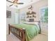 Charming bedroom featuring a wooden bed frame, ceiling fan, natural light, and whimsical decor at 513 Beecham Dr, Smyrna, GA 30082