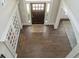 Grand foyer with dark hardwood flooring, front door with sidelights, and transom window at 513 Beecham Dr, Smyrna, GA 30082