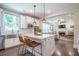 Eat-in kitchen island with stainless steel appliances, white cabinets, and hardwood floors at 513 Beecham Dr, Smyrna, GA 30082