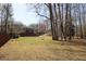 Spacious backyard with mature trees and home in the background at 92 Indian Lake Ct, Hiram, GA 30141