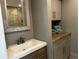 Bathroom with a vanity with wood accents, a sink with bronze faucet, and cabinet space for towel storage at 92 Indian Lake Ct, Hiram, GA 30141