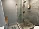 Bathroom with a stand-up glass shower with tiled walls and pebble floor at 92 Indian Lake Ct, Hiram, GA 30141