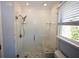 Updated bathroom featuring white textured tile, a modern glass shower, and a marble bench at 92 Indian Lake Ct, Hiram, GA 30141