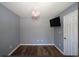 This bedroom features hardwood floors, a pink chandelier, and a mounted TV at 92 Indian Lake Ct, Hiram, GA 30141