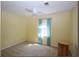 Bedroom with neutral carpet, yellow walls, ceiling fan and a light-filled window with blue curtains at 92 Indian Lake Ct, Hiram, GA 30141