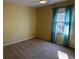 This bedroom features wall-to-wall carpet, a ceiling fan, and ample natural light from the window at 92 Indian Lake Ct, Hiram, GA 30141