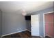 This bedroom features hardwood floors, a pink chandelier, and a mounted TV at 92 Indian Lake Ct, Hiram, GA 30141