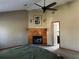 Bedroom with fireplace, ceiling fan, and doorway to what seems to be the bathroom at 92 Indian Lake Ct, Hiram, GA 30141