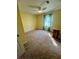 Cozy bedroom with neutral carpet, a ceiling fan, and a window offering natural light at 92 Indian Lake Ct, Hiram, GA 30141