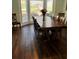 Elegant dining room featuring a large wooden table, chairs, and natural light from a bay window at 92 Indian Lake Ct, Hiram, GA 30141