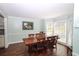 A formal dining room with a large wood table, chairs, and natural light from several windows at 92 Indian Lake Ct, Hiram, GA 30141