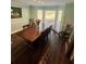 Elegant dining room featuring a large wooden table, chairs, and natural light from a bay window at 92 Indian Lake Ct, Hiram, GA 30141