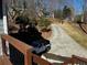 Exterior view of a home's driveway leading up a hill with a jeep parked at the bottom at 92 Indian Lake Ct, Hiram, GA 30141