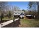 View of home showing a large lawn, mature trees, and additional outdoor storage at 92 Indian Lake Ct, Hiram, GA 30141