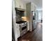 View of stainless steel stove, refrigerator, white cabinets and hardwood floors in kitchen at 92 Indian Lake Ct, Hiram, GA 30141