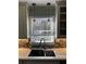 Close-up of kitchen sink with quartz countertops, tile backsplash, and modern pendant lights at 92 Indian Lake Ct, Hiram, GA 30141