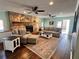 Cozy living room featuring a stone fireplace, hardwood floors, and ample seating with neutral decor at 92 Indian Lake Ct, Hiram, GA 30141