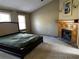 Large main bedroom featuring a fireplace, carpet and many windows at 92 Indian Lake Ct, Hiram, GA 30141