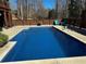 This in-ground pool has clean, clear water and a concrete surround for easy lounging and access at 92 Indian Lake Ct, Hiram, GA 30141