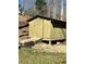 Exterior view of a storage shed with a ramp, set in a grassy backyard at 92 Indian Lake Ct, Hiram, GA 30141