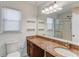 Bathroom featuring an extended vanity and large framed mirror at 2685 Whippoorwill Cir, Duluth, GA 30097